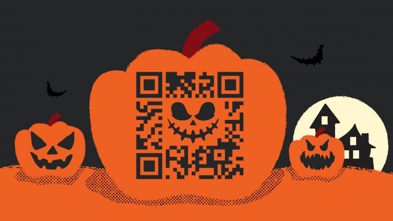 Jack-o'-lantern with QR code on it, jack-o'-lanterns and haunted house in background