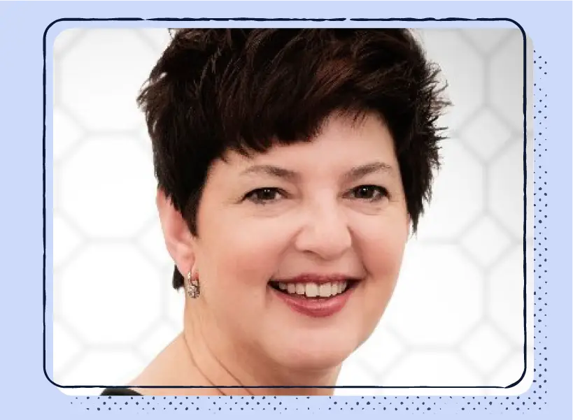 A headshot of a smiling woman with short hair.